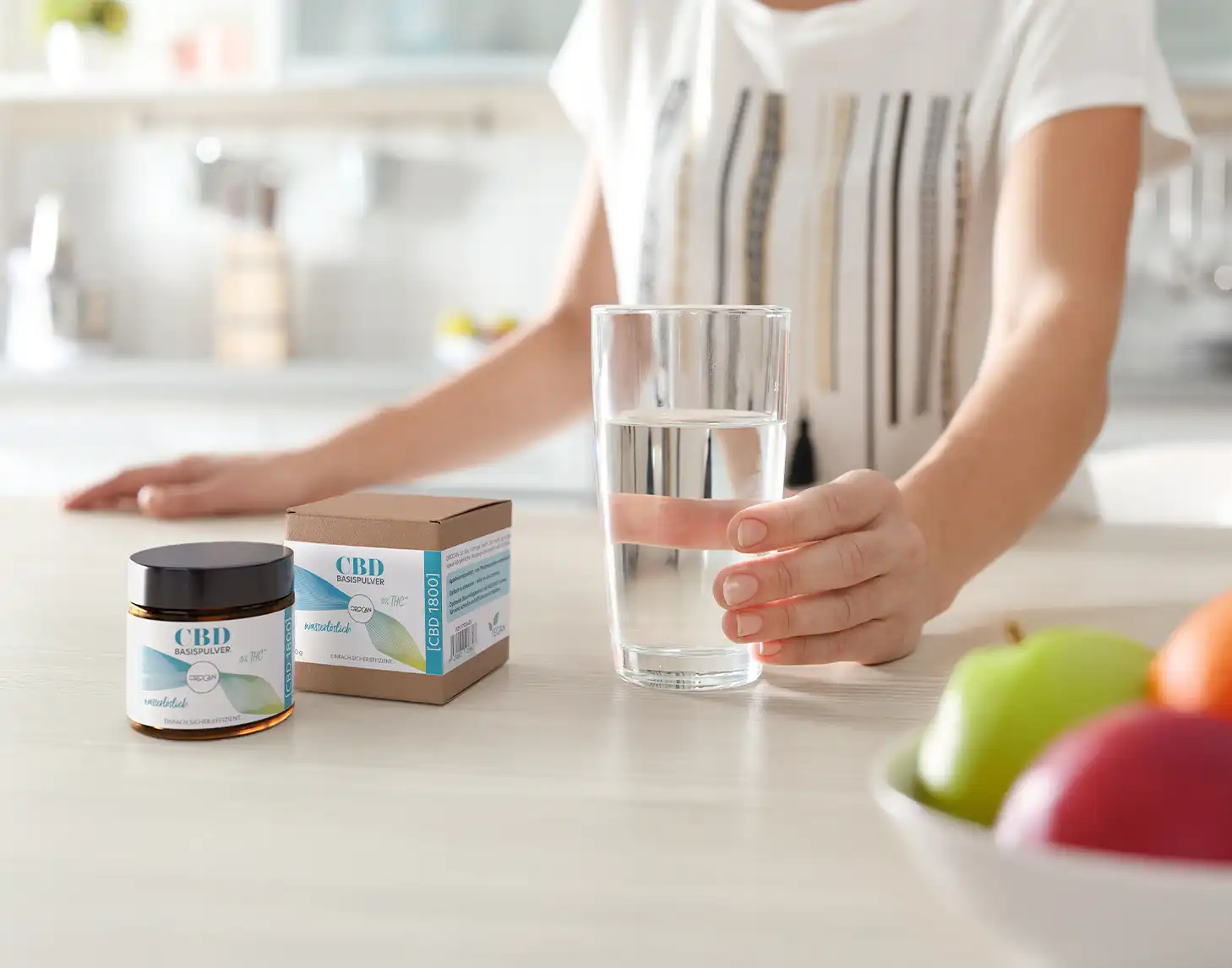 Eine Hand hält ein Glas Wasser